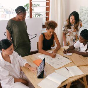 diverse group of woman collaborating at desk