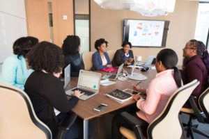 women discussing business at a conference table