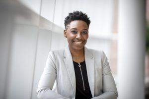 black woman in suit smiling