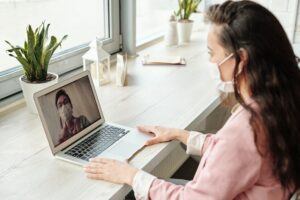 woman having a video call with masks on