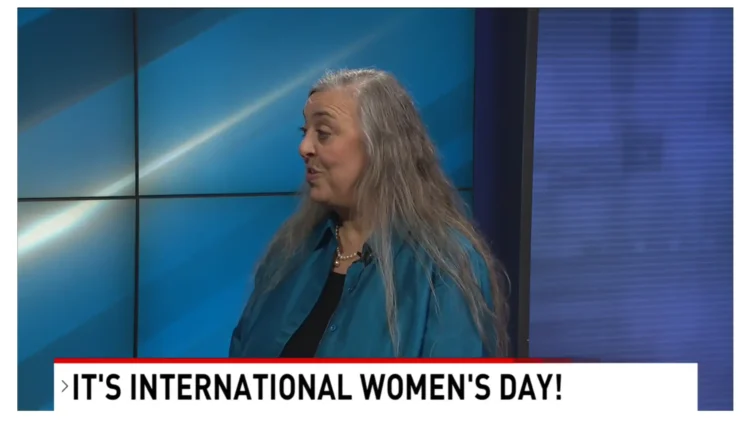 woman speaking on-camera to journalist